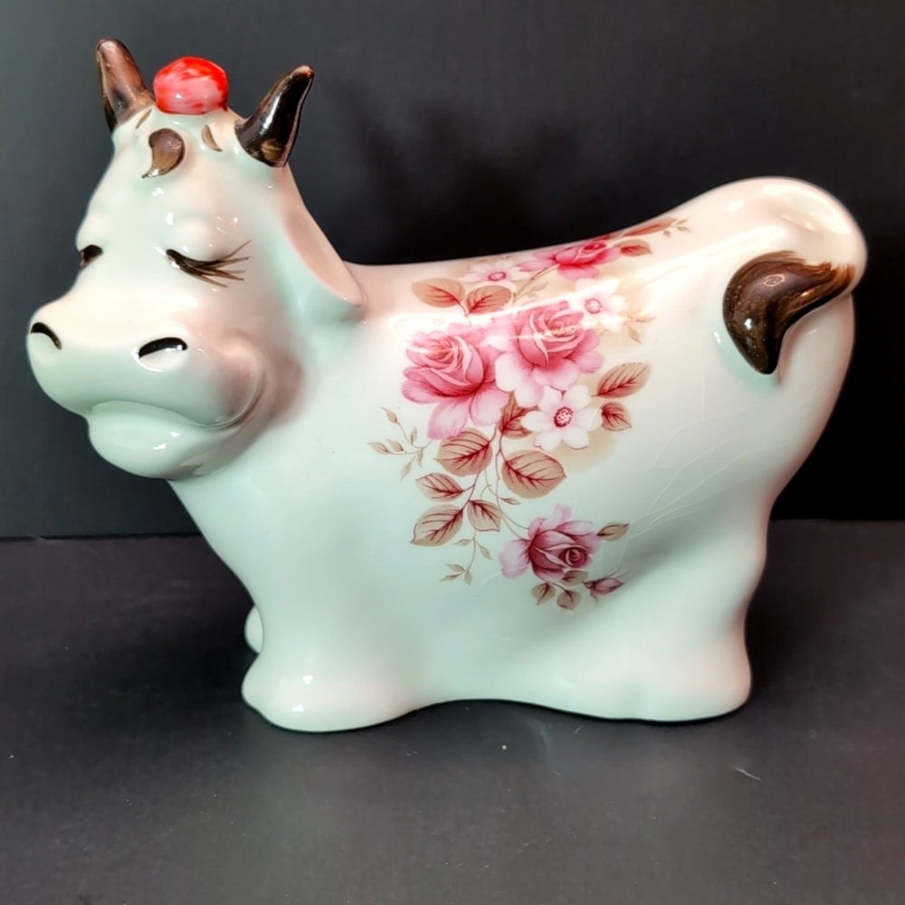 Vintage Rosie the Cow Ceramic White/Pink Floral Coin Bank.